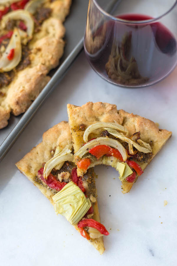 Gluten Free Pesto Pizza: A simple, delicious homemade pizza made with ingredients like pesto, roasted red peppers, and fennel! || fooduzzi.com recipes