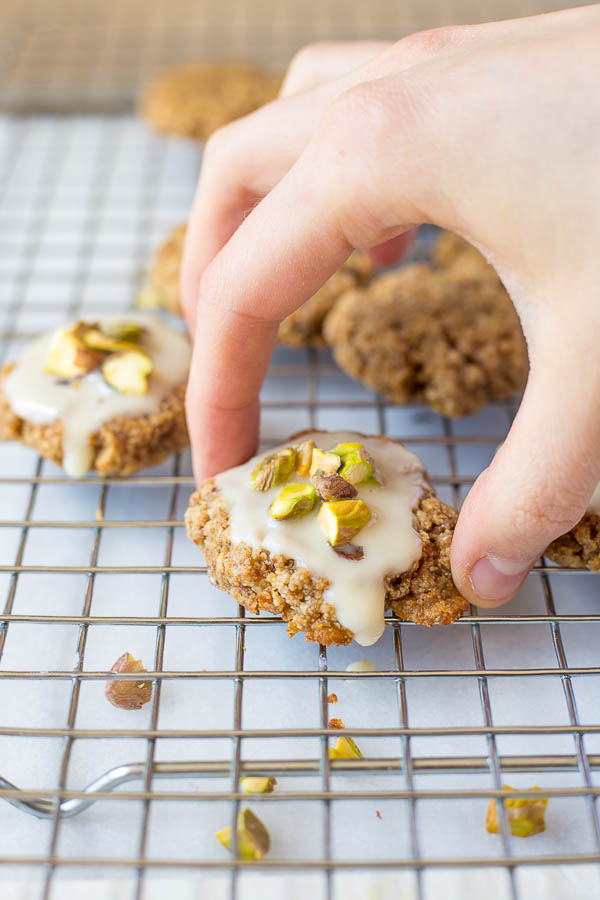 Chewy Lemon Cookies with Coconut Icing and Pistachios: a healthy, gluten free, and vegan cookie that's incredibly chewy and full of fresh flavors! This recipe is refined sugar-free! || fooduzzi.com recipe