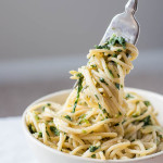 Creamy Spinach Artichoke Hummus Pasta: A healthy, gluten free, and vegan 10 minute meal! You'll love this healthier play on the classic spinach artichoke dip! || fooduzzi.com recipe