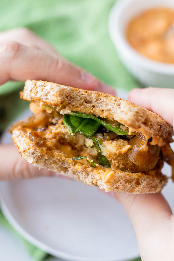 Italian-Style Chickpea Burgers: packed with healthy, vegan, and gluten free ingredients and topped with caramelized onion, hummus, and basil! Perfect for Father's Day and summer cookouts! || fooduzzi.com recipe