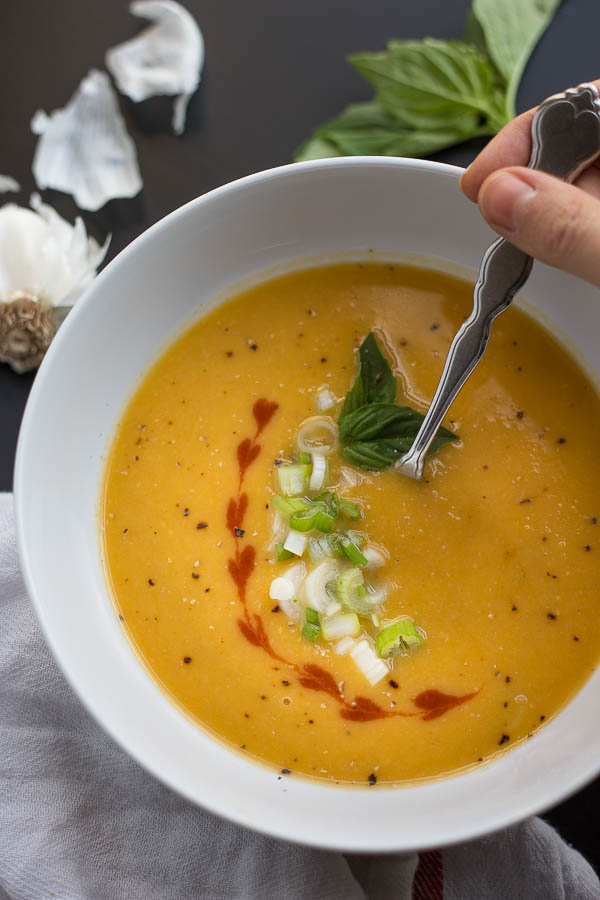 bowl of thai peanut butternut squash soup with toppings