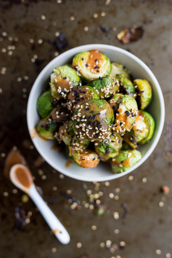 Sriracha Almond Butter Roasted Brussels Sprouts: these are ADDICTIVE! A naturally gluten free, vegan, and healthy side, these will be your newest obsession! || fooduzzi.com recipe