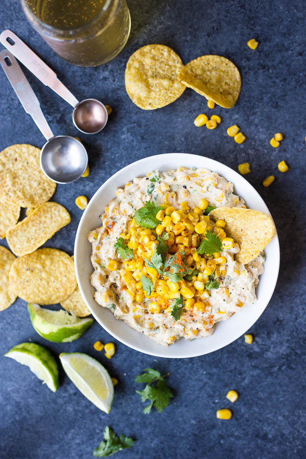 Vegan Elote Corn Dip: a quick and easy dip perfect for summer picnics and parties! Made with healthy ingredients like hummus, corn, and fresh herbs! || fooduzzi.com recipe
