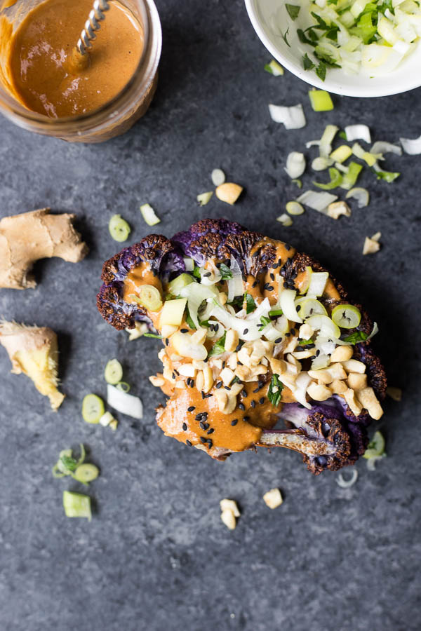 Thai Peanut Cauliflower Steaks: A quick and easy dinner recipe that's sure to satisfy! Serve with quinoa, zucchini noodles, rice, or other roasted veggies for a delicious and filling vegan and gluten free dinner! || fooduzzi.com recipe