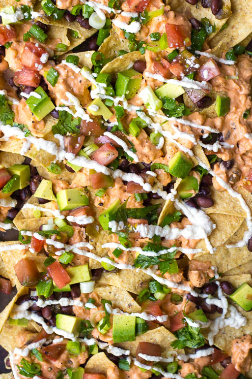 Vegan Buffalo Chickpea Nachos: Simple vegan nachos...with a kick! Naturally gluten free and easily customizable for your taste buds! Perfect for game day. || fooduzzi.com recipe
