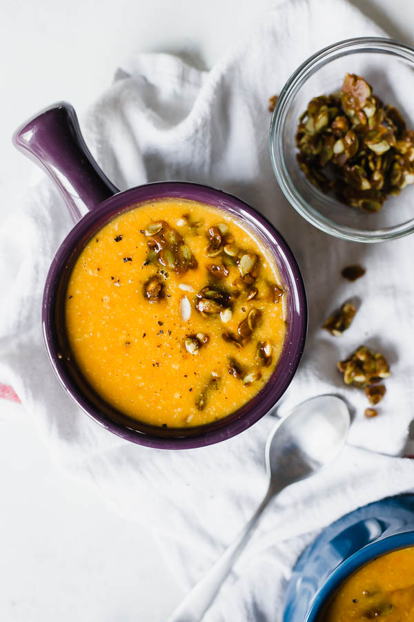 Vegan Butternut Carrot Bisque with Curried Pepita Brittle: A simple, cozy bisque that's creamy, full of flavor, and totally vegan! Don't skip the crunchy and sweet curried pepita brittle! || fooduzzi.com recipe #soup #vegan #easydinner