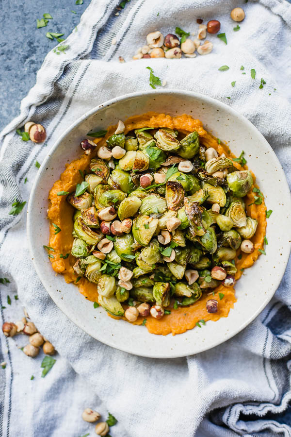 roasted brussels sprouts on sweet potato mash in a bowl