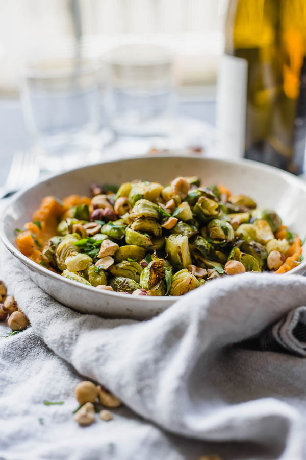 roasted brussels sprouts on sweet potato mash in a bowl