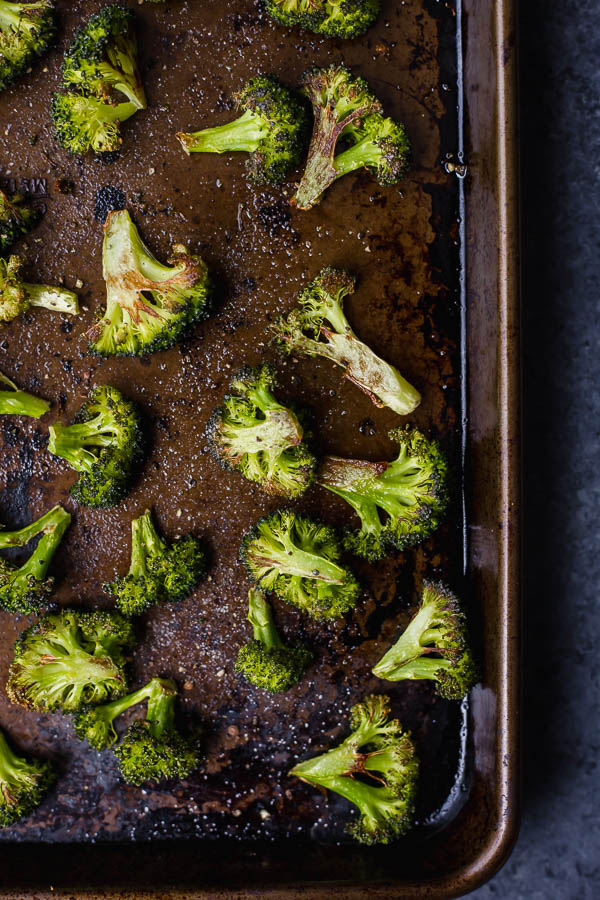 Easy Vegan Parmesan Roasted Broccoli: A super simple and delicious way to eat your veggies! If you're not a broccoli fan, I can almost guarantee it's because you've never had it roasted - it's the BEST. || fooduzzi.com recipe #broccoli #healthyrecipe #vegetables