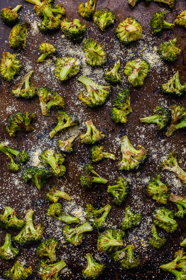 Easy Vegan Parmesan Roasted Broccoli: A super simple and delicious way to eat your veggies! If you're not a broccoli fan, I can almost guarantee it's because you've never had it roasted - it's the BEST. || fooduzzi.com recipe #broccoli #healthyrecipe #vegetables