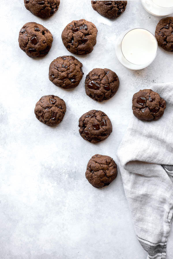 chocolate cookies on a white background with milk and a towel