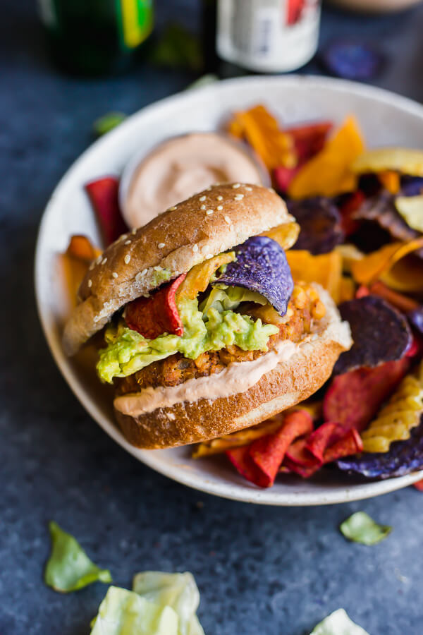 a plate with chips and a vegan guacamole crunch burger
