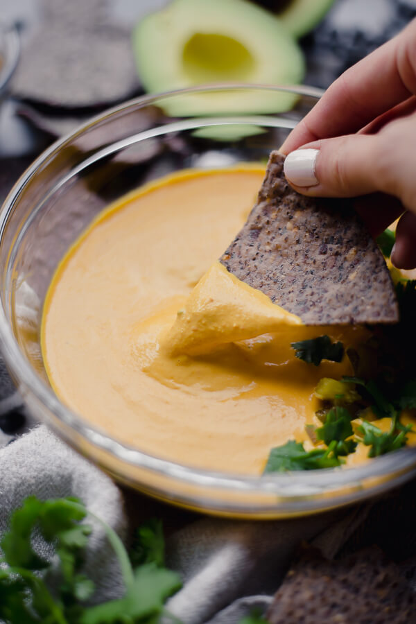 chip in a bowl of vegan queso