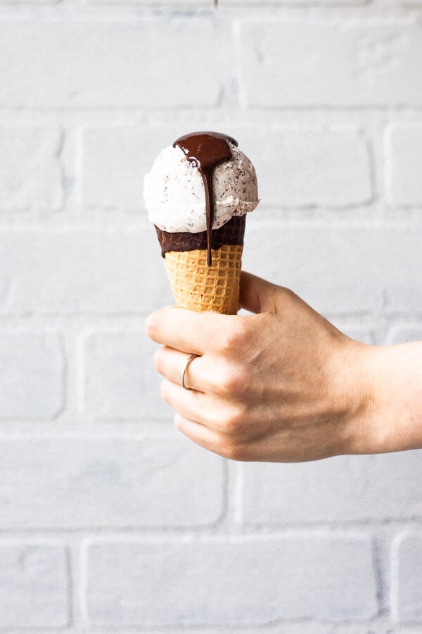 a cone of vegan mint chocolate chip ice cream