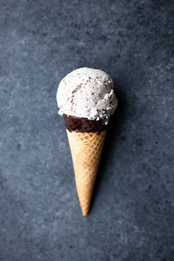a cone of vegan mint chocolate chip ice cream