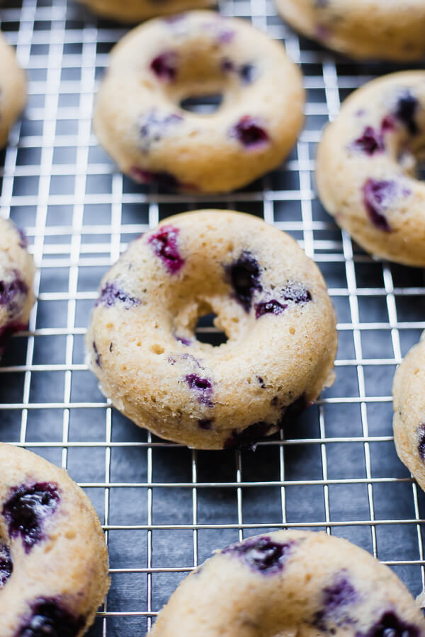 baked vegan blueberry donuts on a cooling rack
