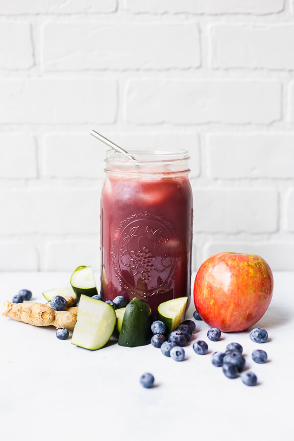 a mason jar with juice and fruit