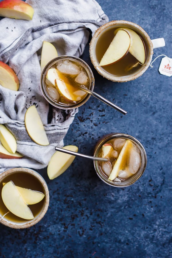 cups of apple cider tea with straws and apple slices