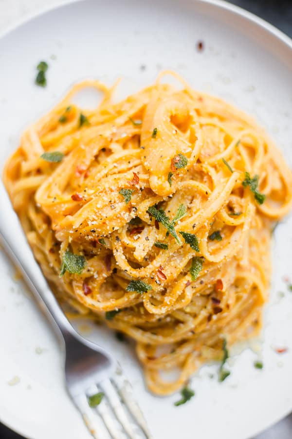 a plate of pumpkin pasta with a fork