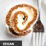 a slice of vegan pumpkin roll on a plate with a fork
