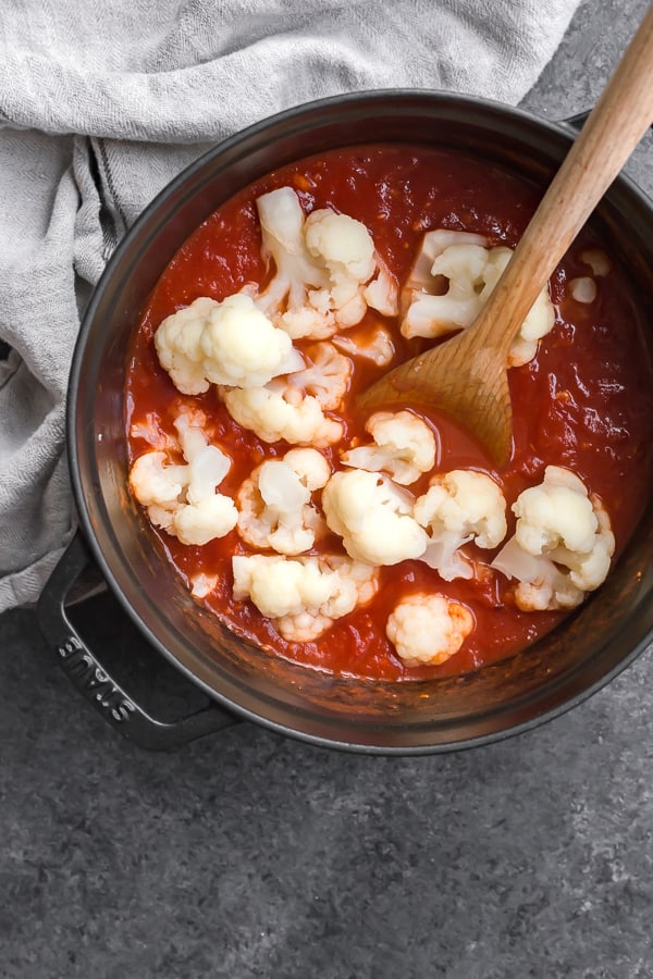 a pot of san marzano tomato soup with cauliflower in it