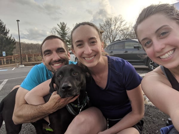 three runners and a dog smiling