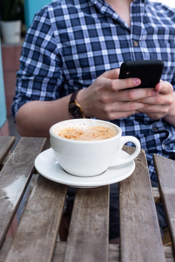 white coffee cup on a saucer and a wooden table