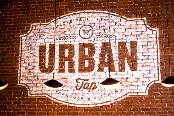 brick building with Urban Tap painted on it