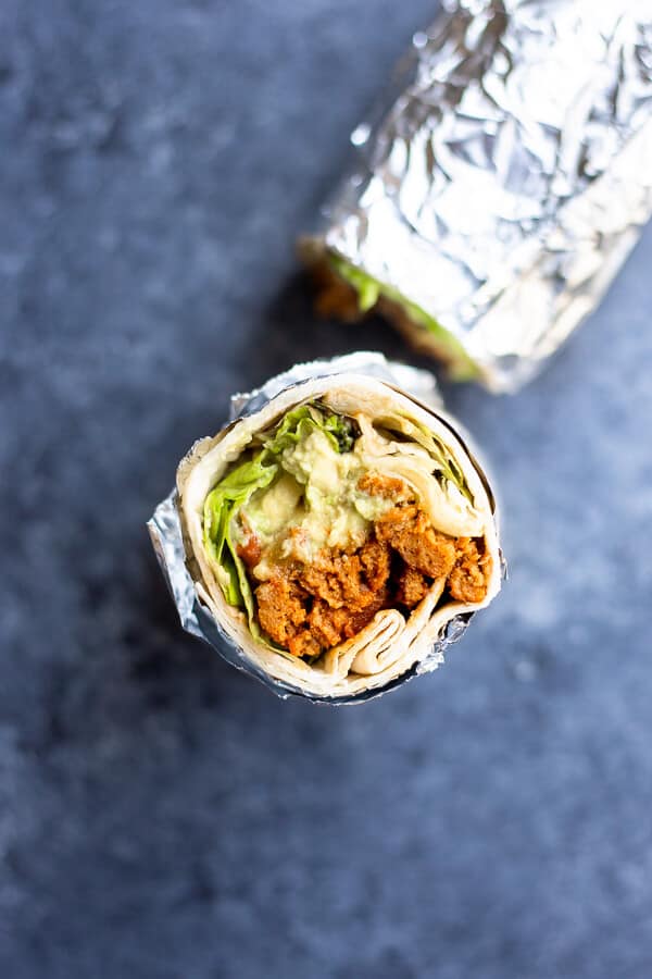 vegan seitan burrito cut and wrapped in aluminum foil