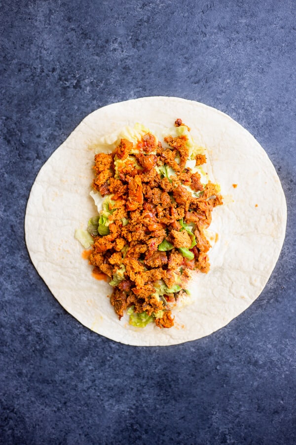 tortilla with vegan seitan burrito ingredients on top