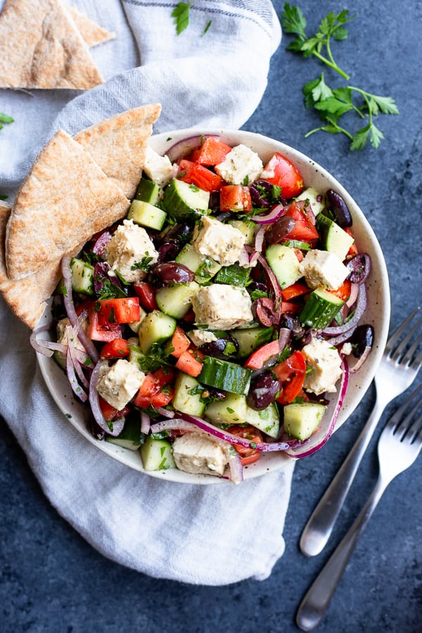 The Greek Salad with Tofu Feta from the Food52 Vegan cookbook in a bowl with pita