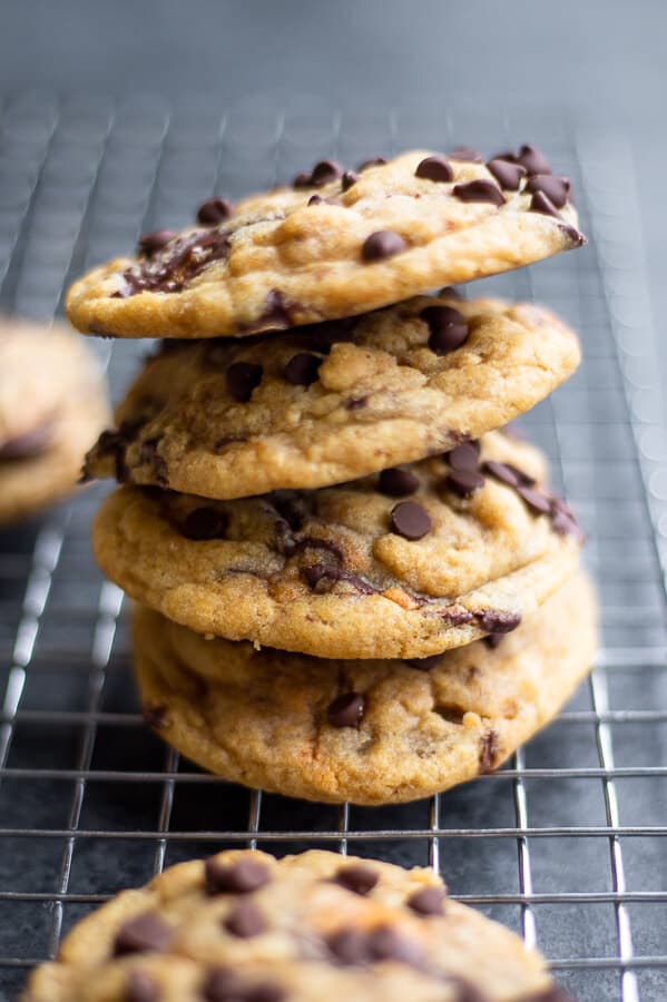 A stack of Chewy Vegan Peanut Butter Cup Cookies on a cooling rack