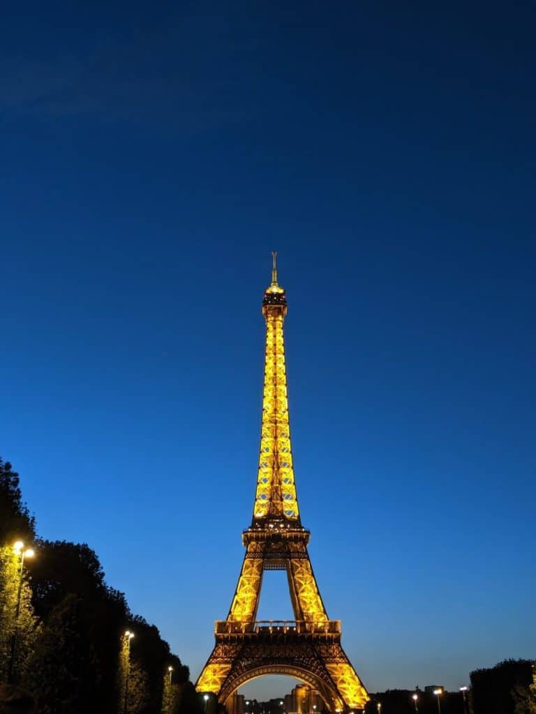 The Eiffel Tower against a blue twilight sky