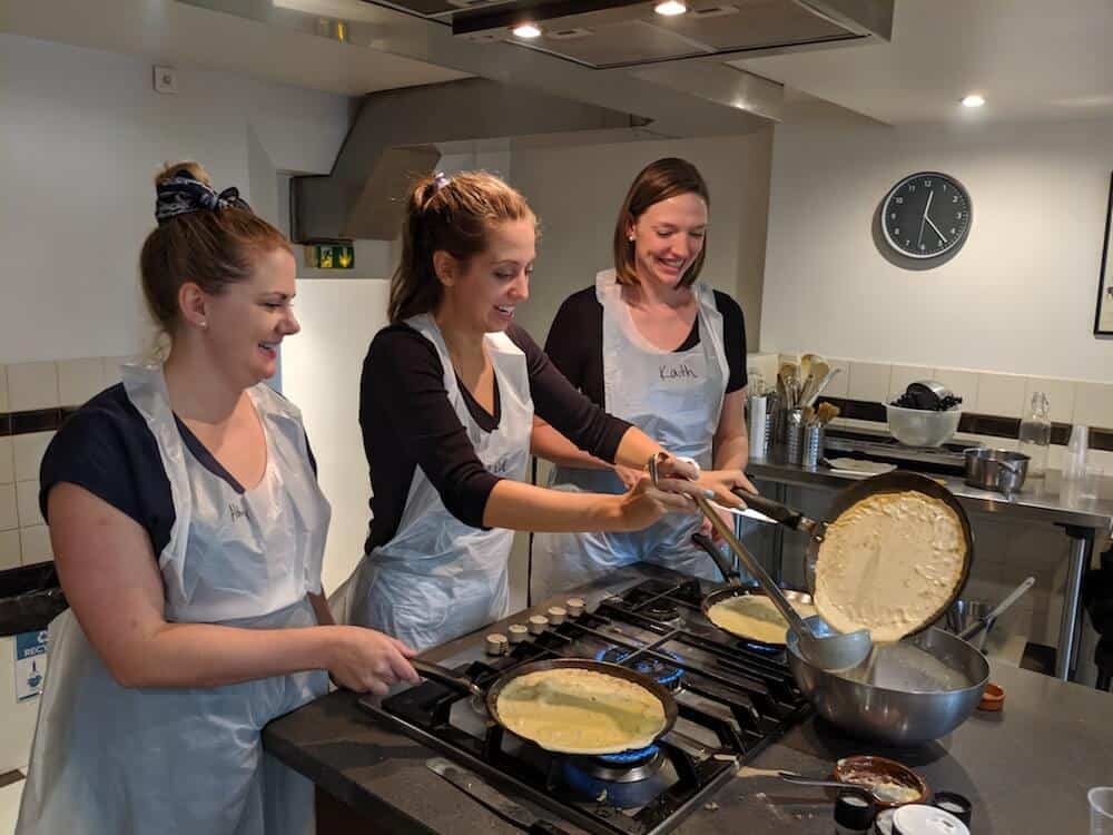 three girls making crepes in France