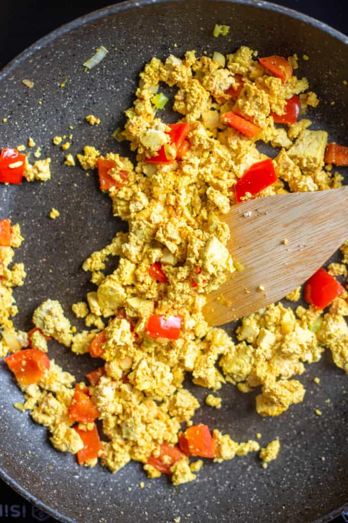 tofu scramble with peppers and onion in a pan