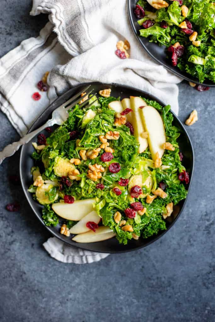 Kale Brussels Sprout Salad with Maple Dijon Dressing on a black plate