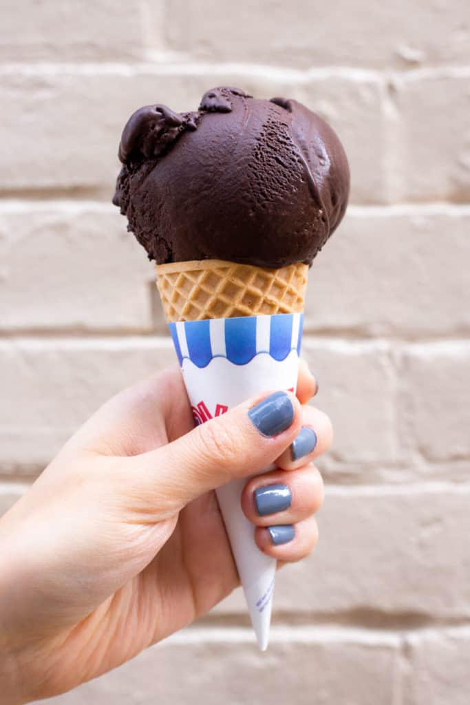 an ice cream cone with dairy free brownie batter ice cream from Millie's Homemade in Pittsburgh, Pennsylvania
