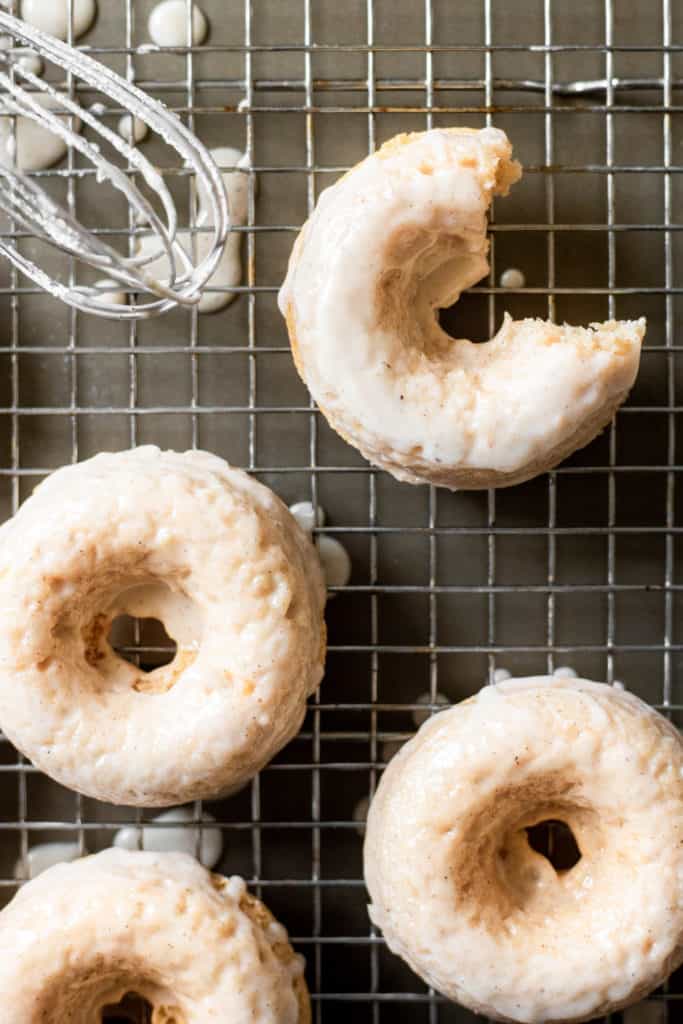 glazed baked vanilla bean donuts with a bite taken out of one