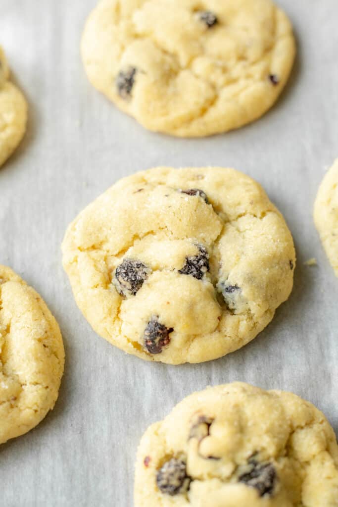 baked vegan lemon blueberry sugar cookies on a parchment-lined baking sheet