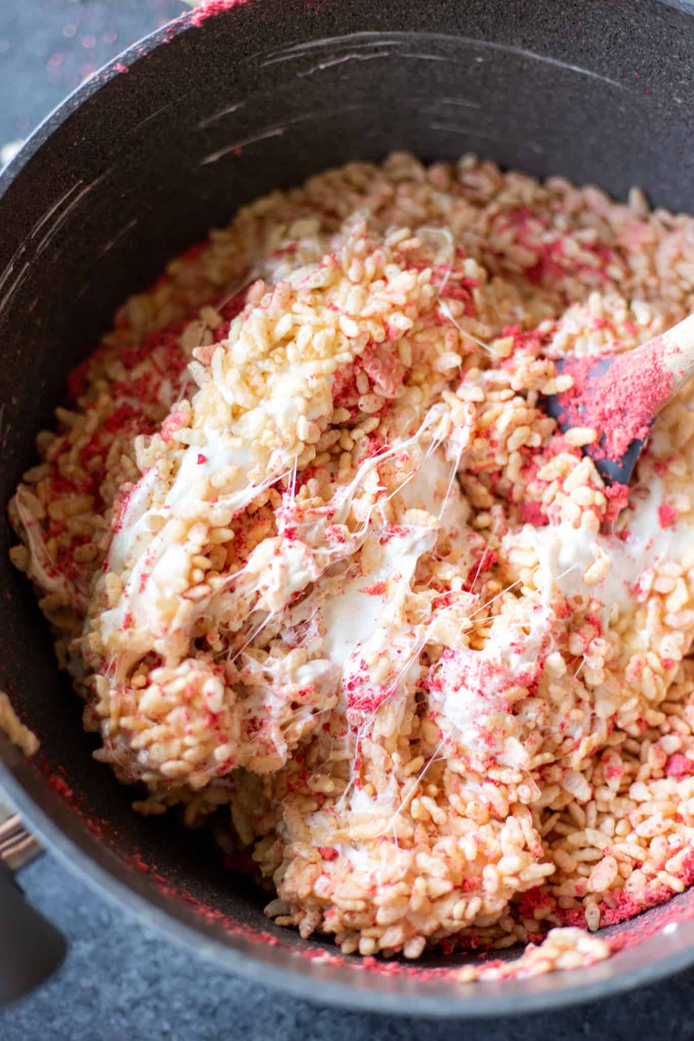 a pot filled with strawberries and cream crispy rice treat mixture