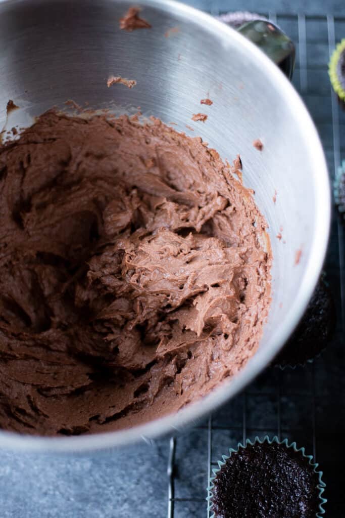 chocolate peanut butter ganache frosting in a large metal bowl