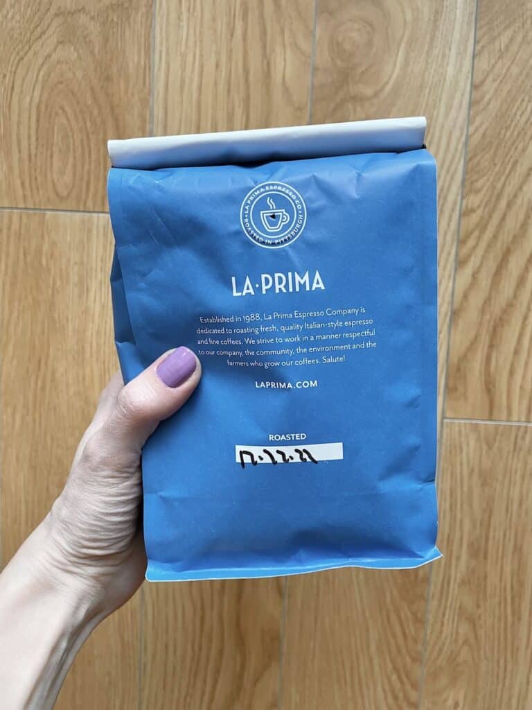 a bag of La Prima coffee with the roast date written on the back