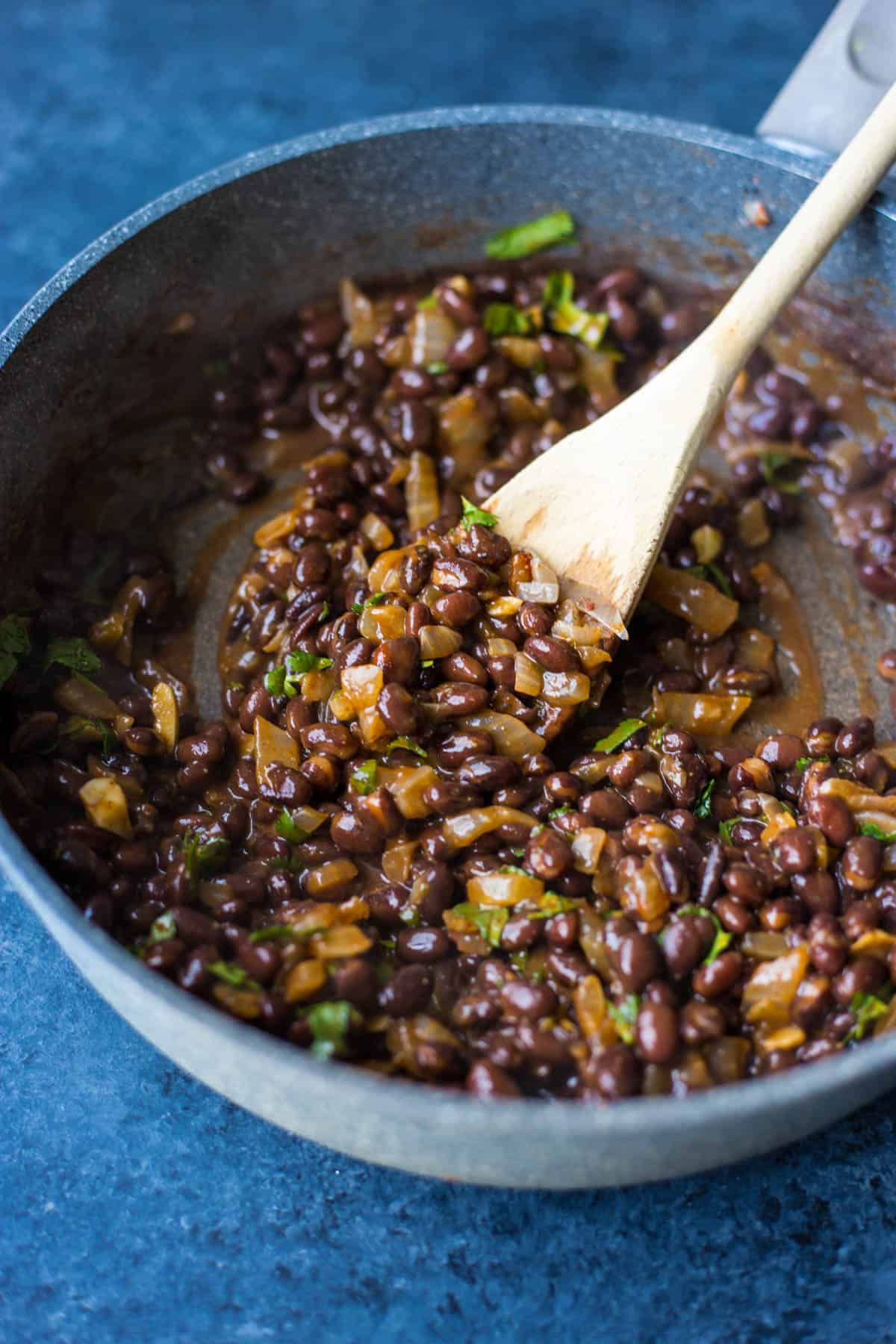 creamy stewed vegan black beans in a pan