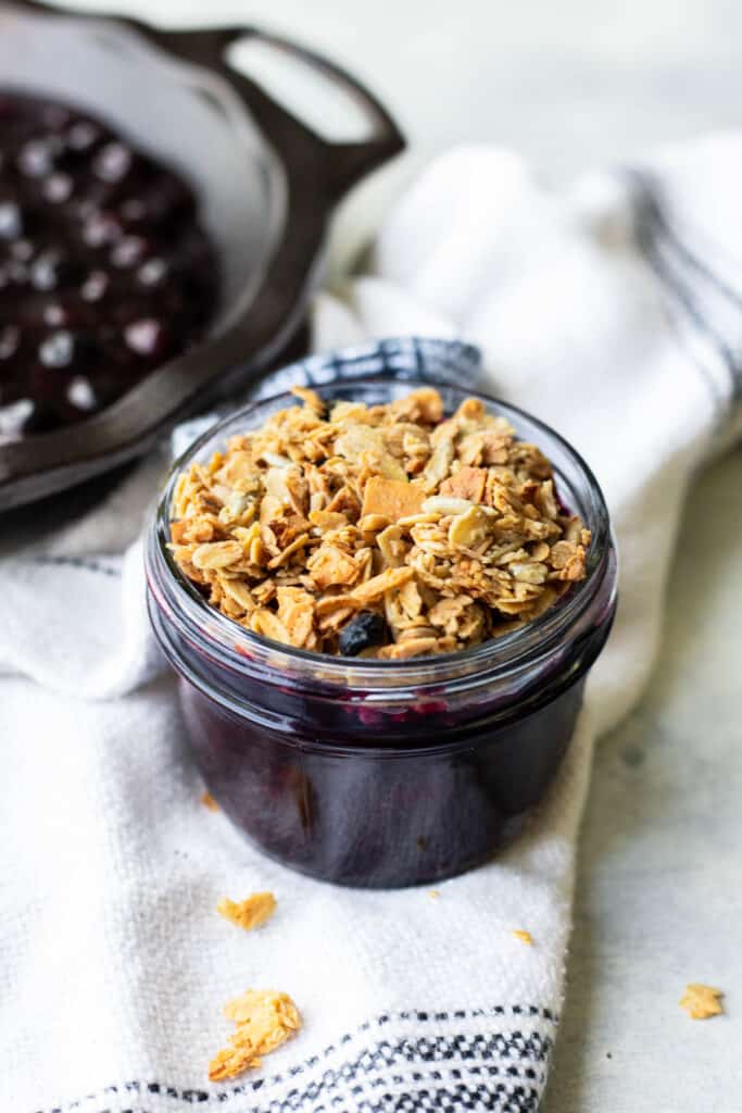 individual stovetop blueberry crumble in a small mason jar