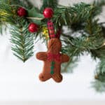 A gingerbread man Cinnamon ornament hanging on a garland