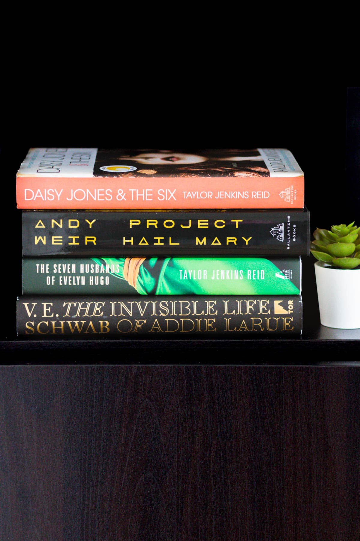 A stack of four books, Daisy Jones and the Six, Project Hail Mary, The Seven Husbands of Evelyn Hugo, and The Invisible Life of Addie La Rue