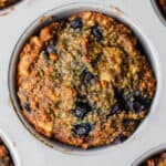 a Vegan Blueberry Walnut Oatmeal Muffin in a muffin pan