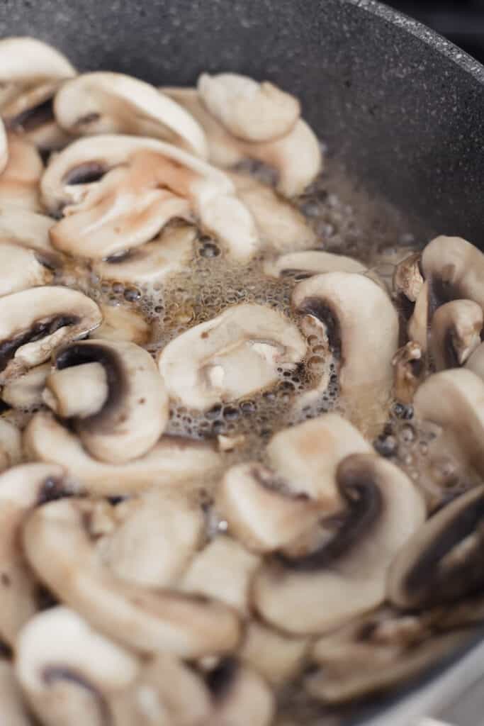 mushrooms boiling in water in a pan
